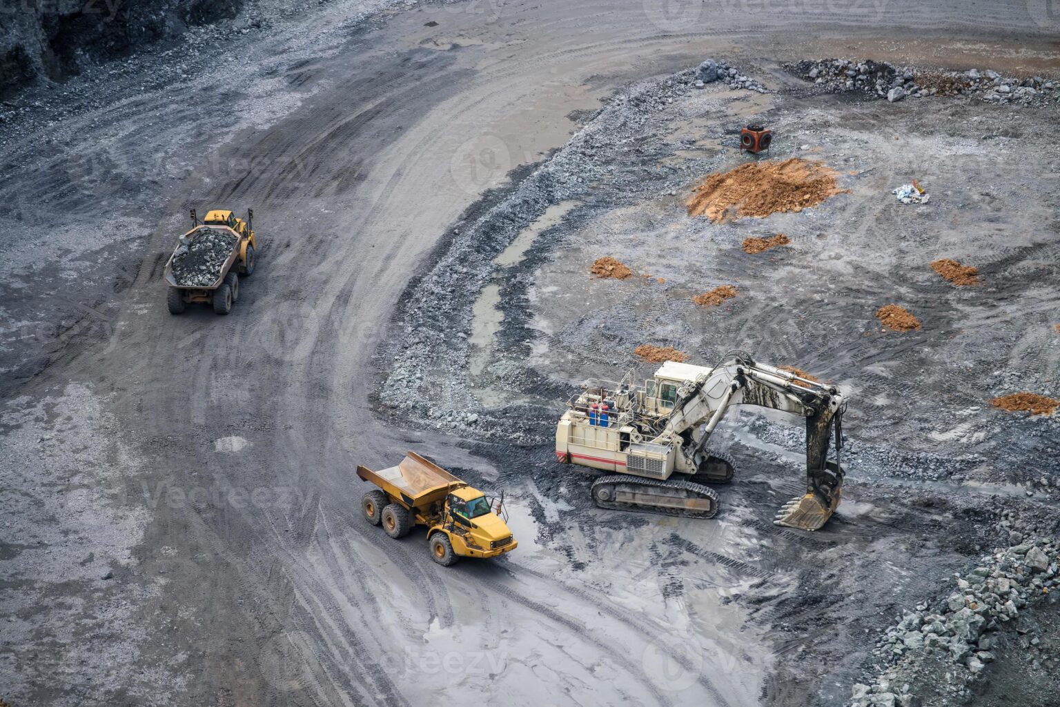 work-of-trucks-and-the-excavator-in-an-open-pit-on-gold-mining-photo-1536x1025